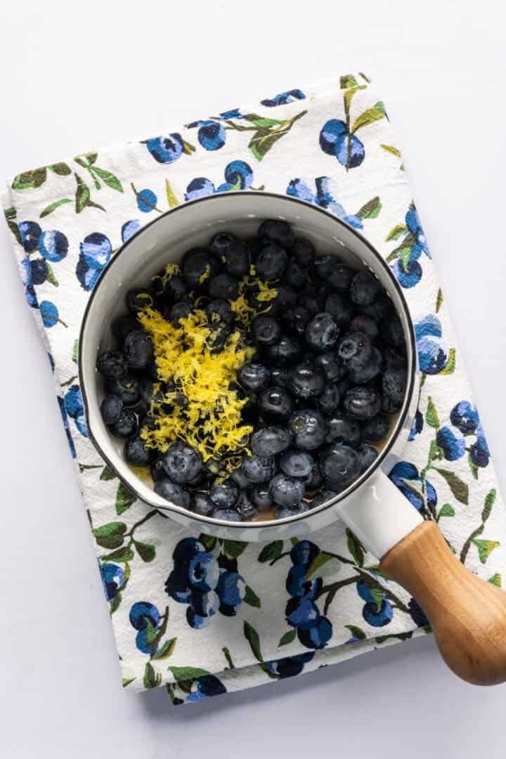 Blueberry lemon compote ingredients in saucepan before cooking. 