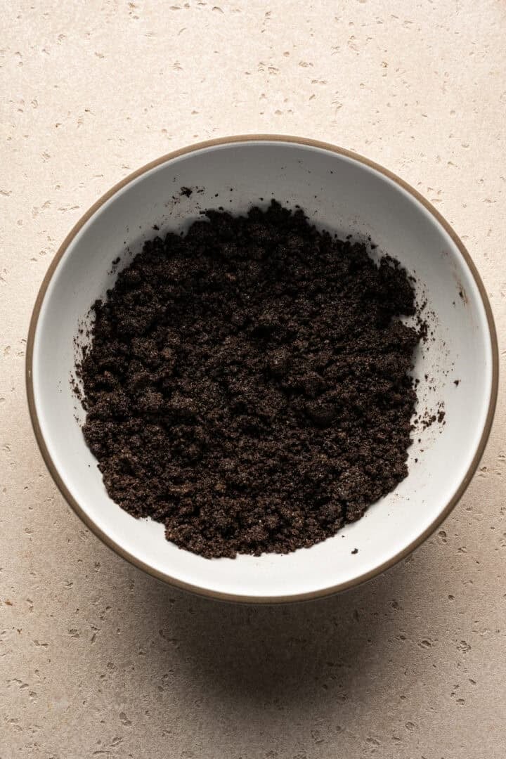 Overhead view of oreo crumbs in a mixing bowl.