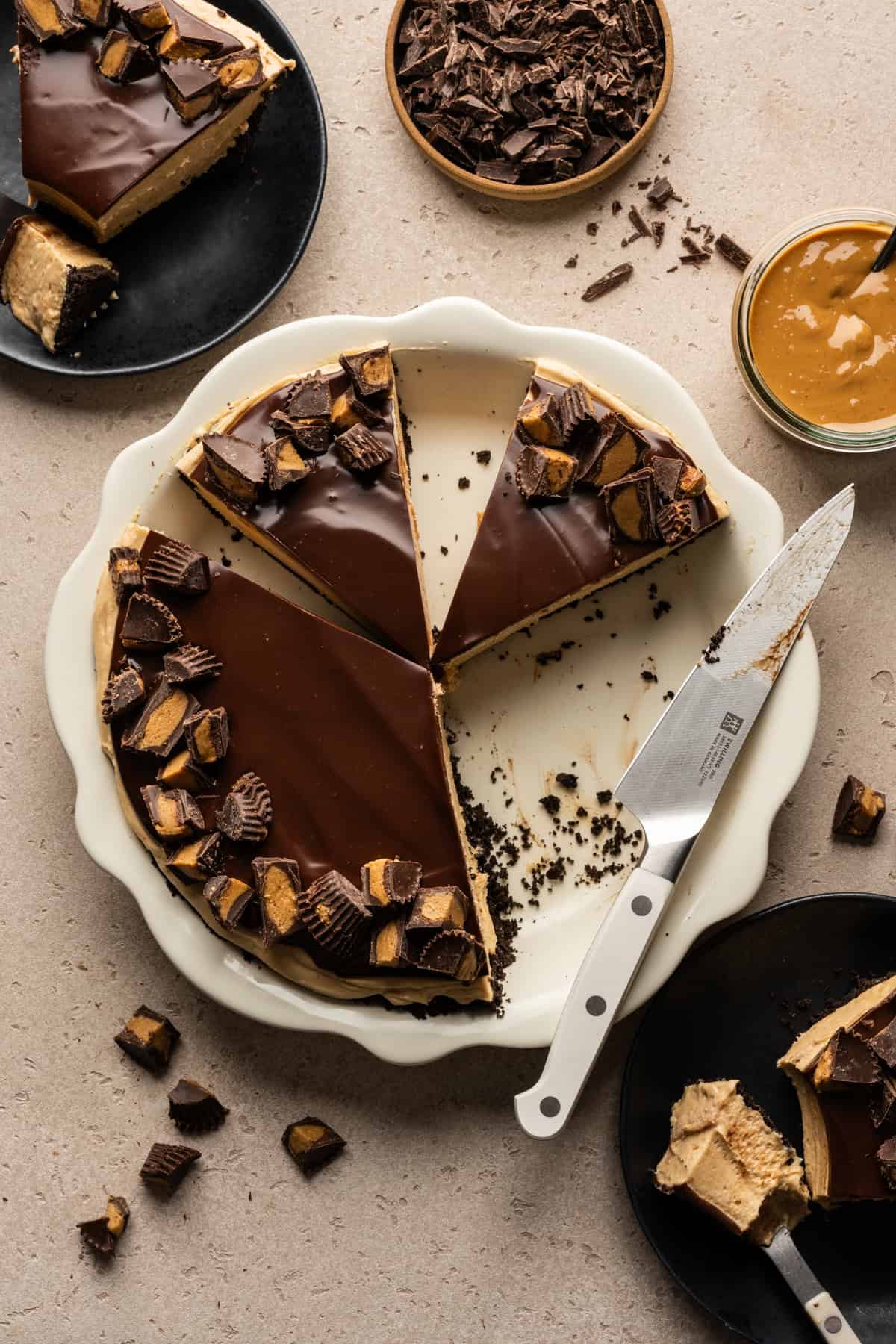 Overhead view of peanut butter mousse pie with several slices removed.