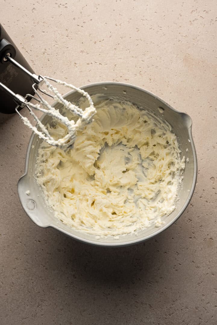 Overhead view of creaming cream cheese for the mousse pie filling.