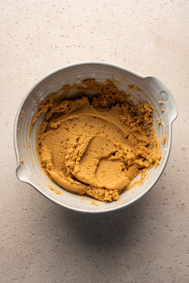 Overhead view of half of the peanut butter mousse filling ingredients in a mixing bowl.