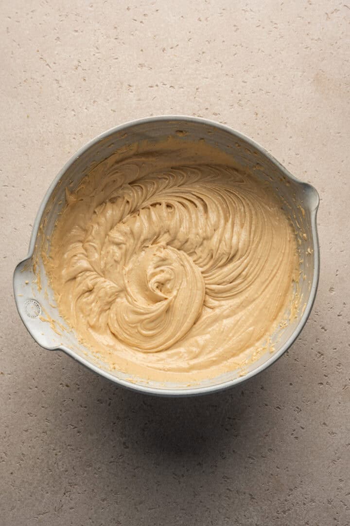 Overhead view of peanut butter mousse in a mixing bowl.