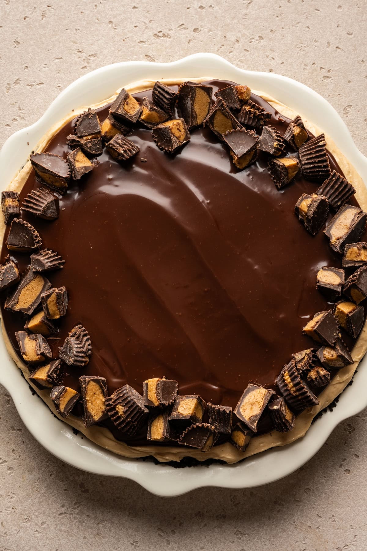 Overhead view of finished peanut butter mousse pie topped with peanut butter cups.