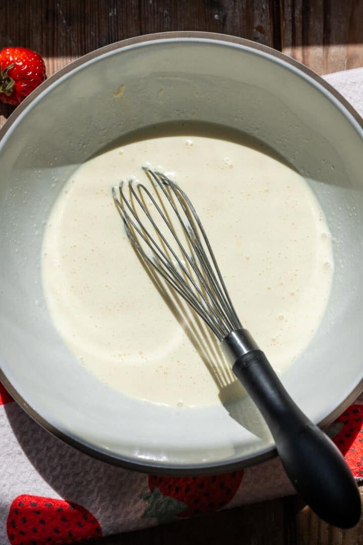 Milk, egg and vanilla whisked together in a bowl.