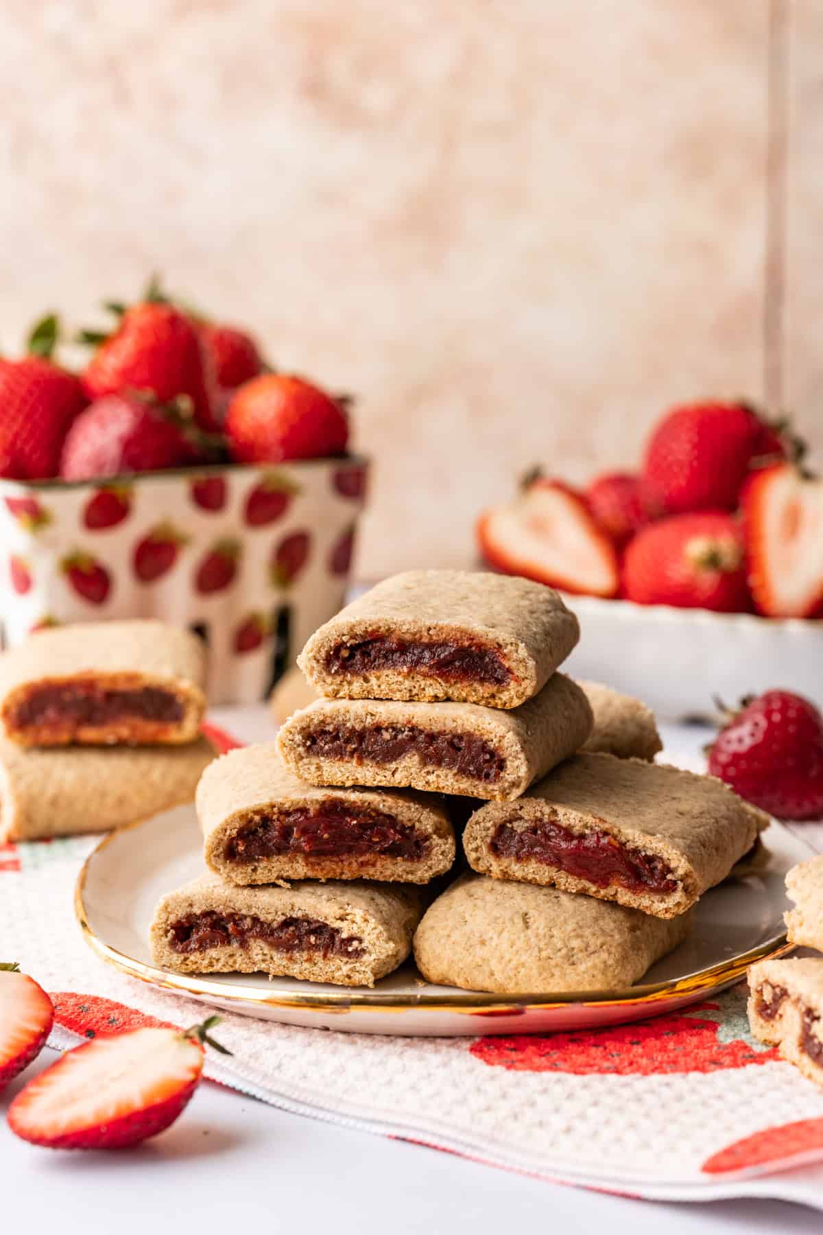 Homemade strawberry nutrigrain bars stacked on a plate.