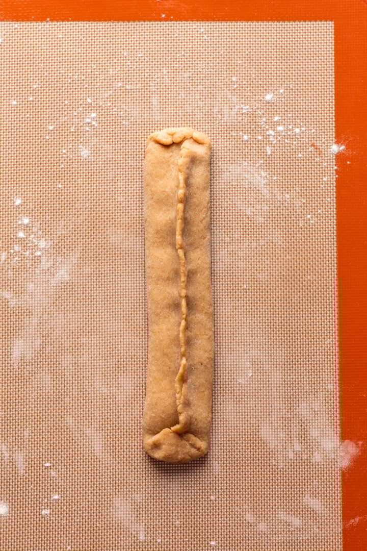 Nutrigrain bar dough in a rectangle with seams pinched together.