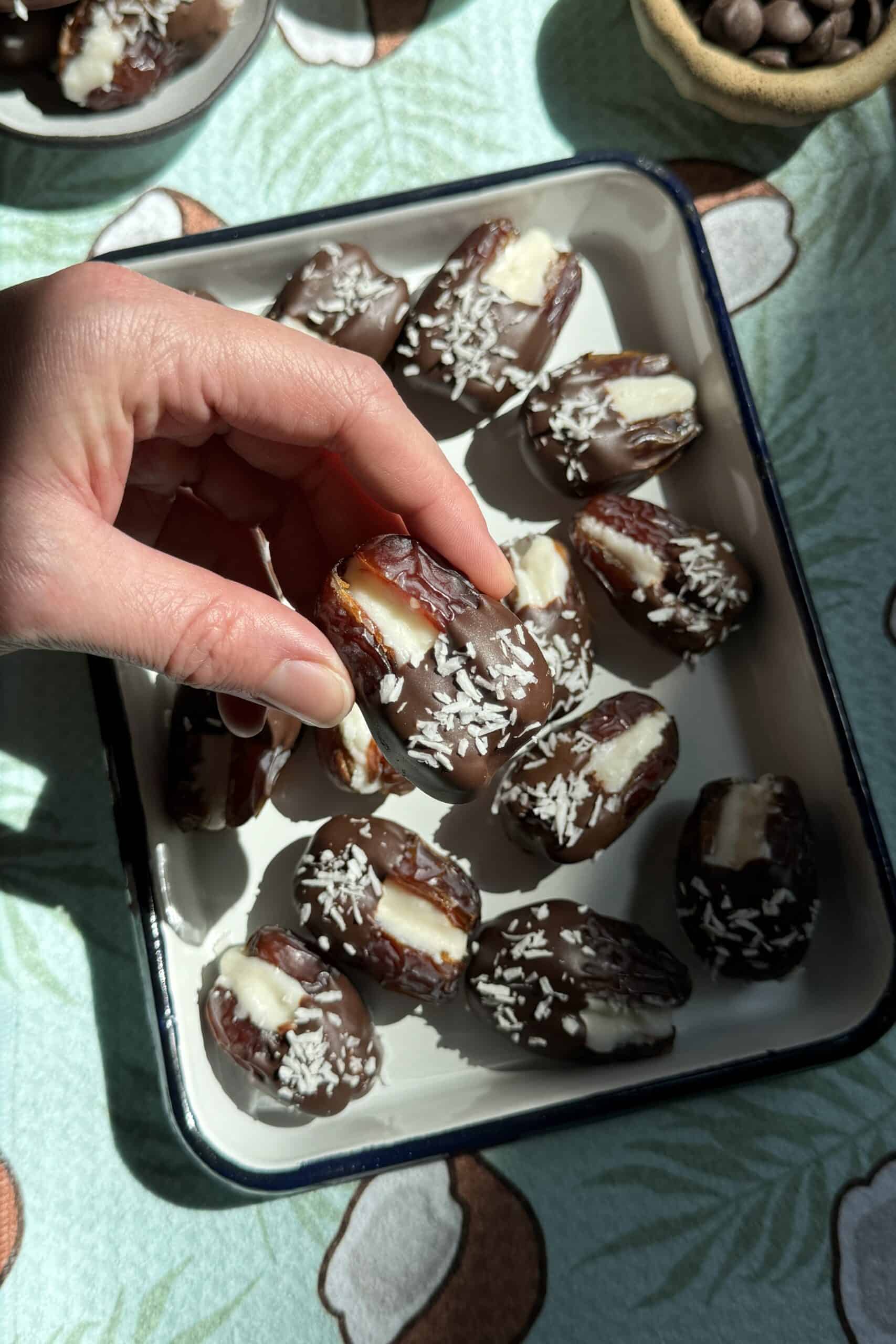 Mounds bar dates stuffed with coconut butter and dipped halfway in dark chocolate. 