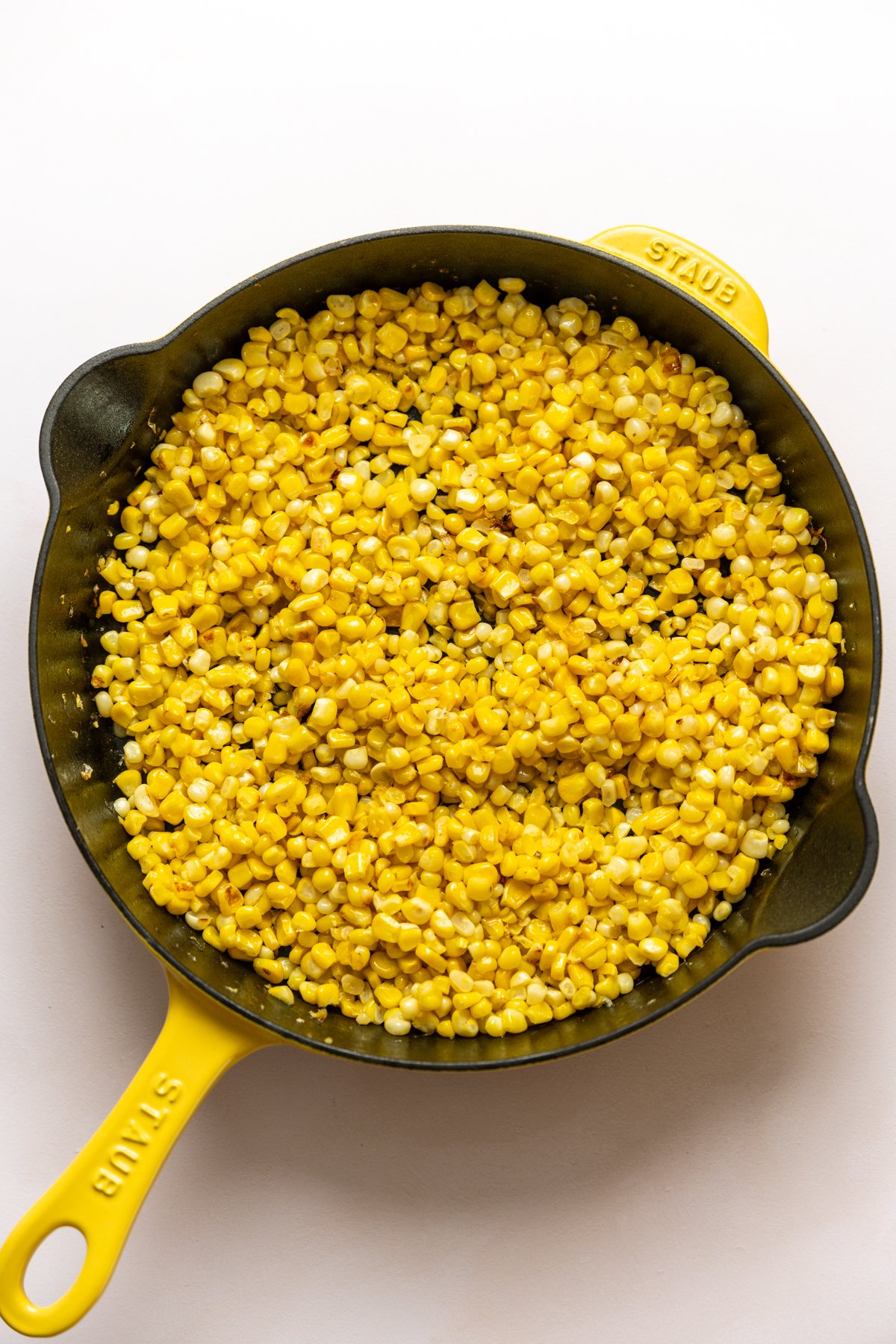 overhead view of sauteed corn in a skillet.