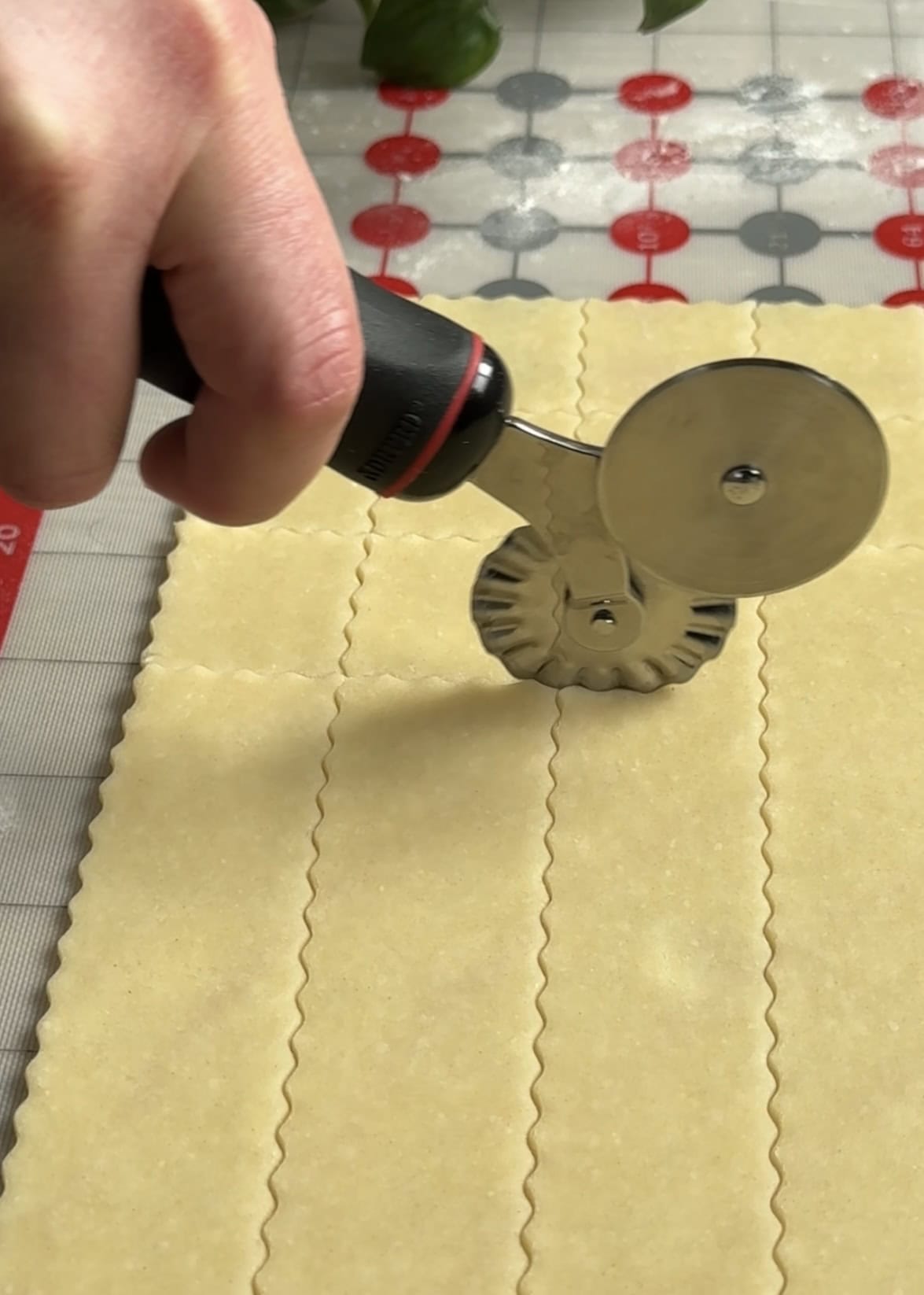Fluted pastry wheel cutting cheez its. 
