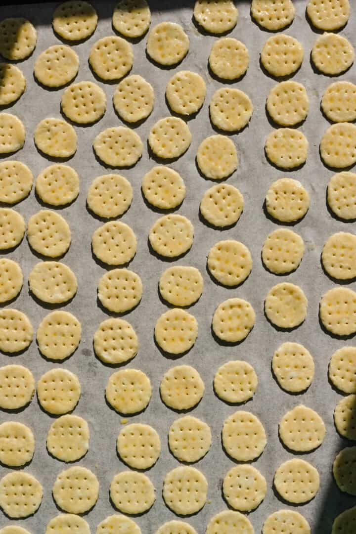 Homemade ritz crackers on sheet pan before baking.