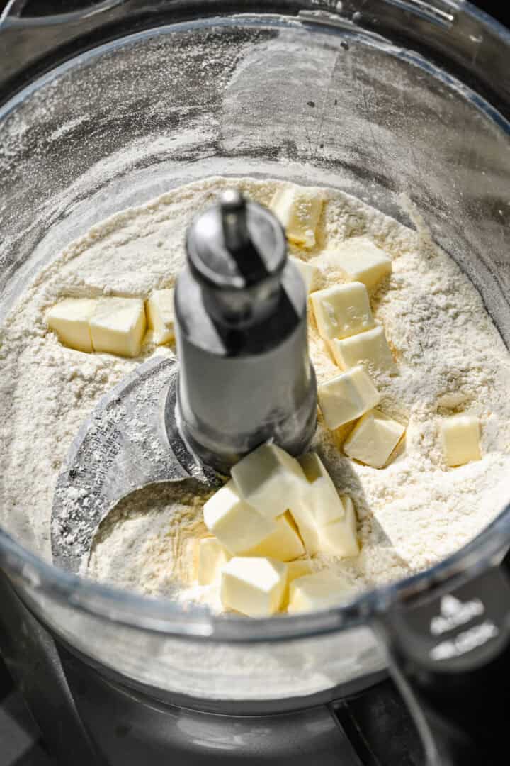Flour and cubed butter in food processor.