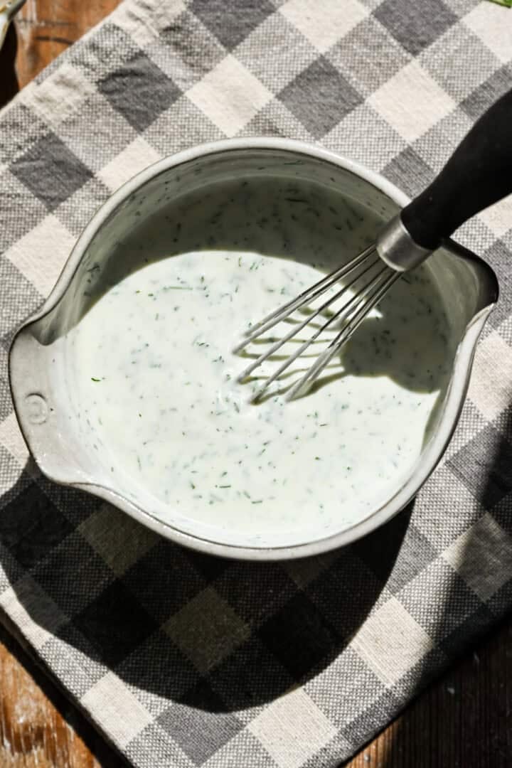 Yogurt dill sauce ingredients in a bowl after whisking together.