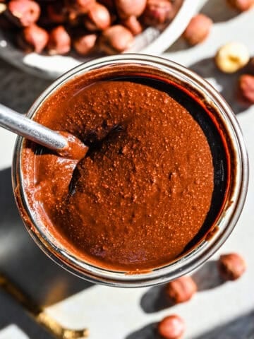 Overhead view of homemade nutella in a glass jar.