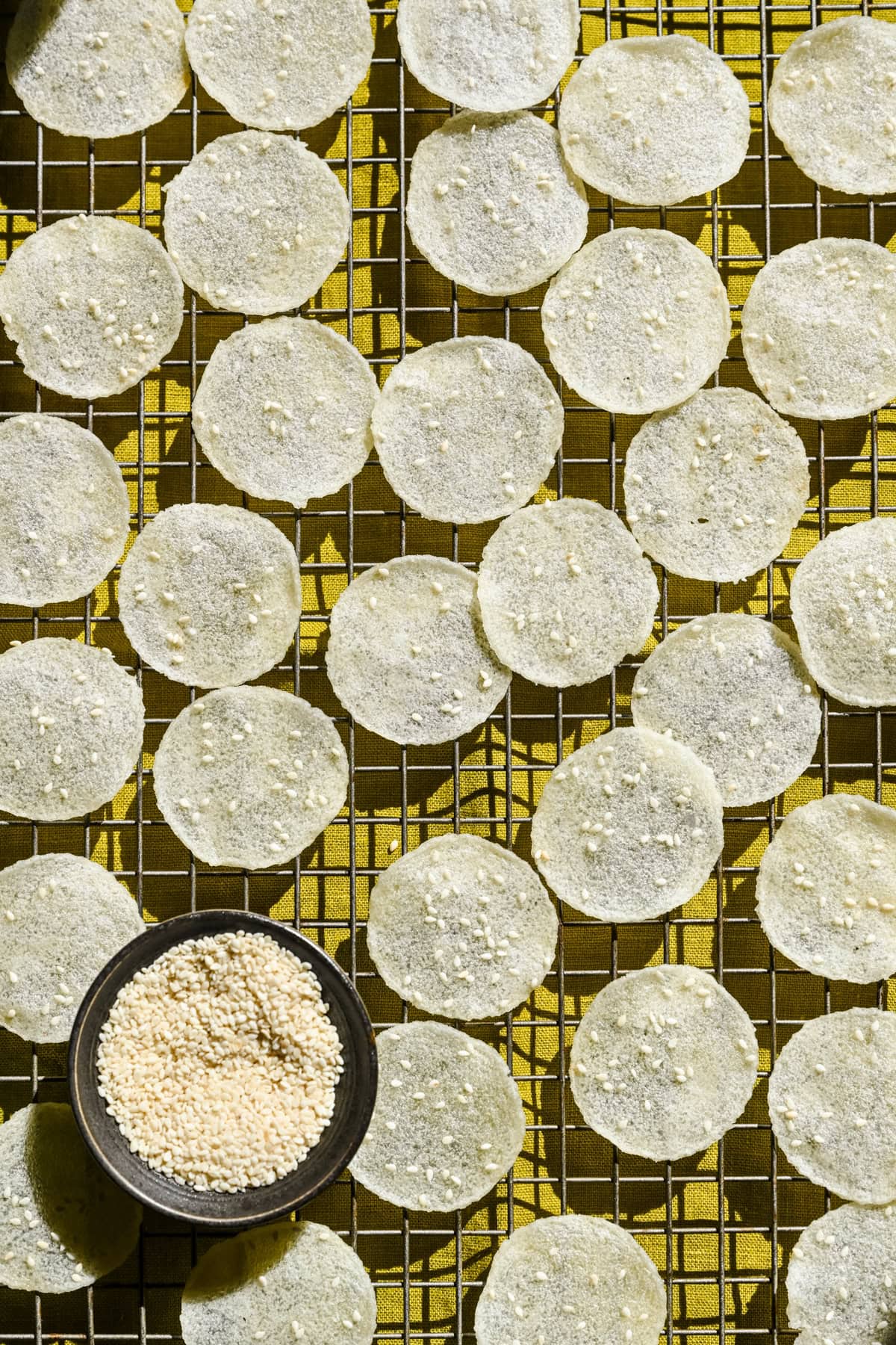Overhead view of rice crackers on a cooling rack.