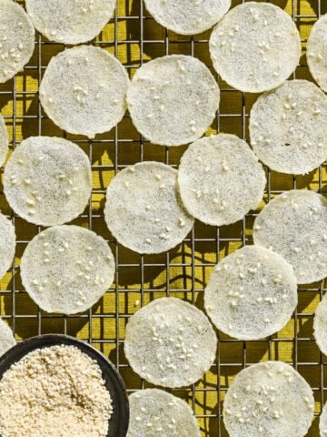 Overhead view of rice crackers on a cooling rack.