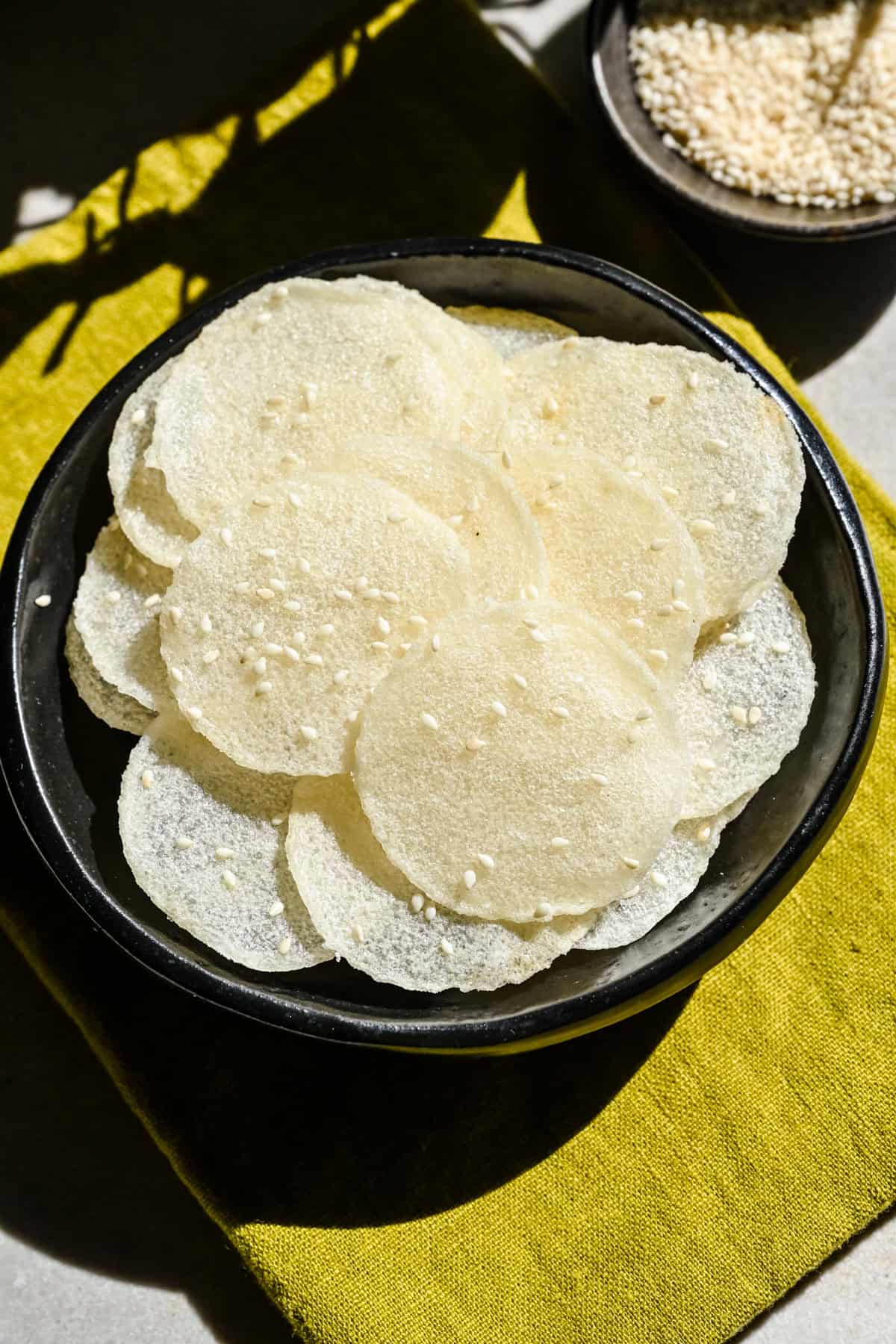Overhead view of several rice crackers in a bowl.