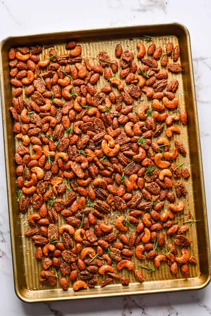 Overhead view of roasted nuts on a sheet pan.