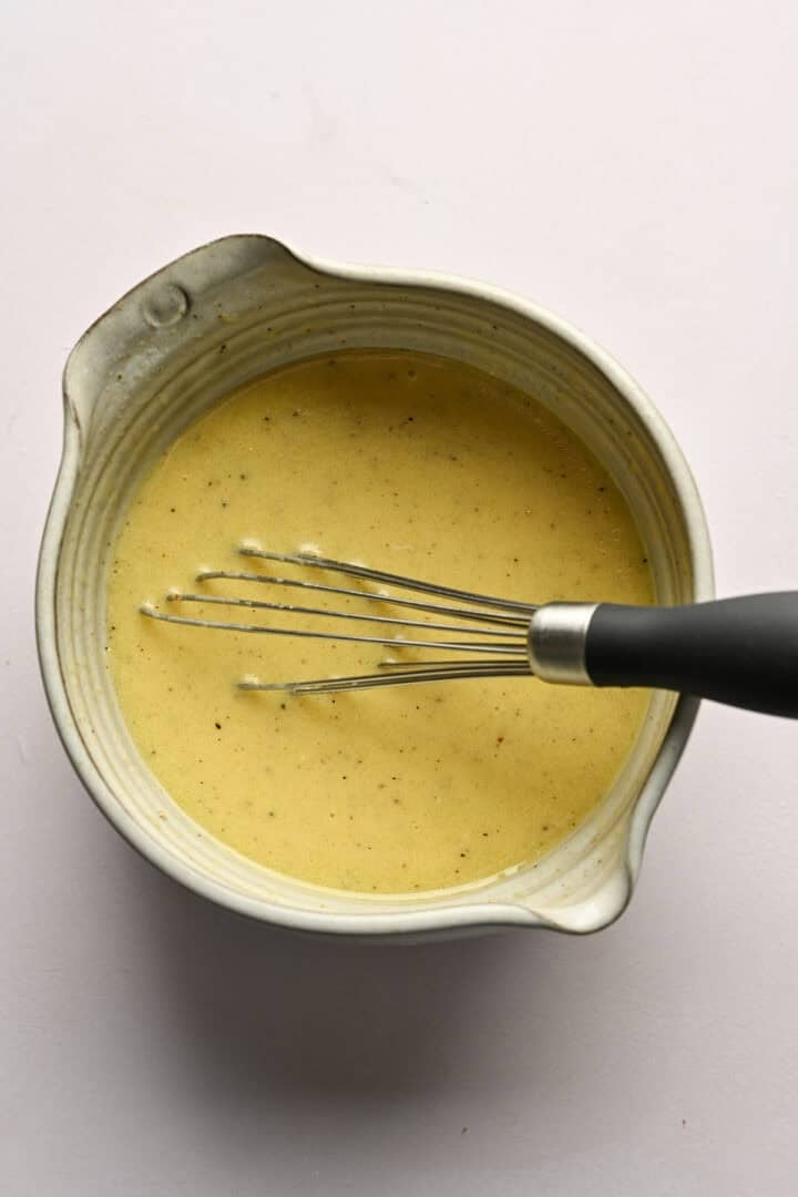 After whisking together ingredients for honey mustard dressing in small bowl.