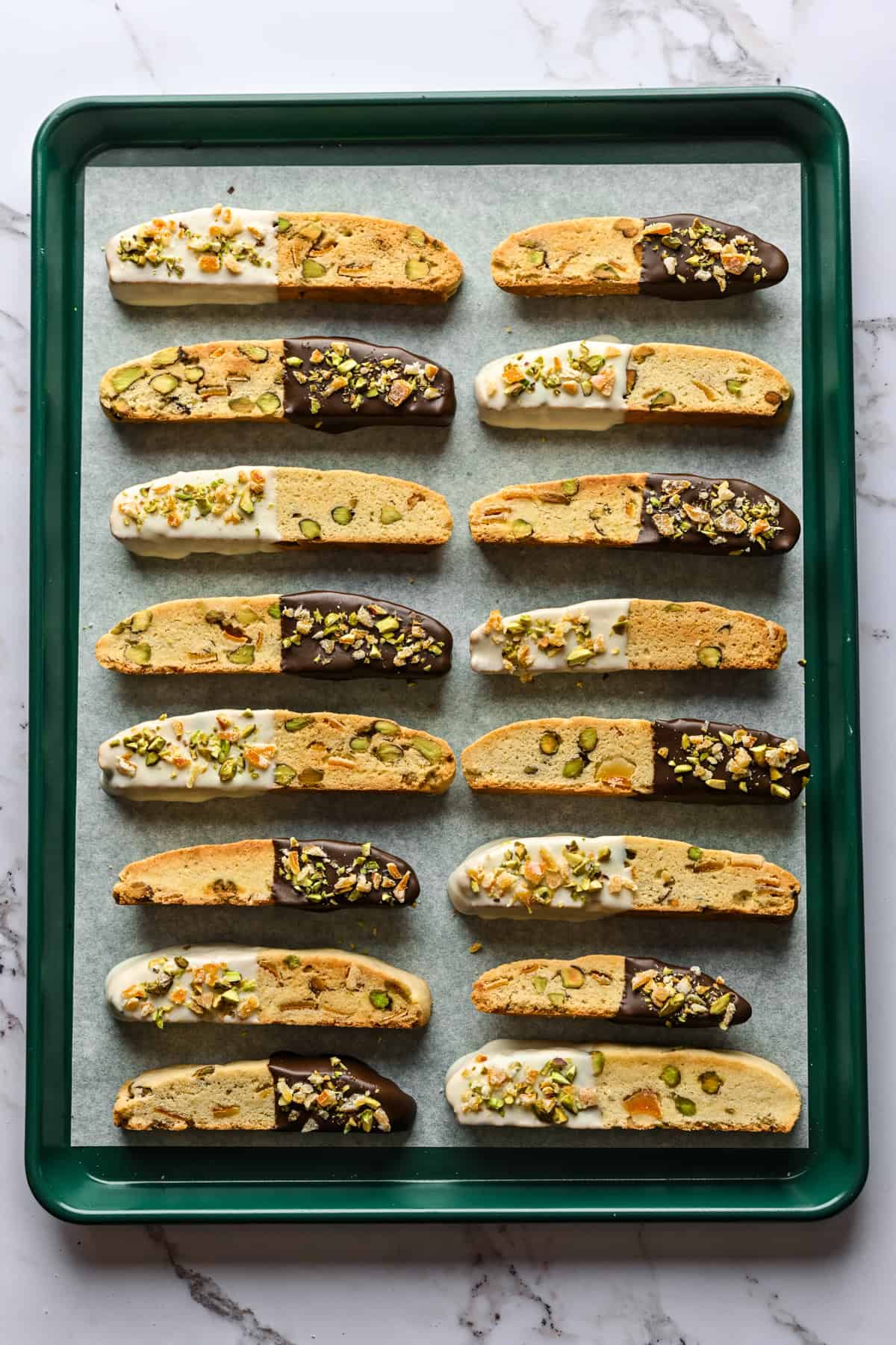 Overhead view of biscotti set atop a sheet pan.