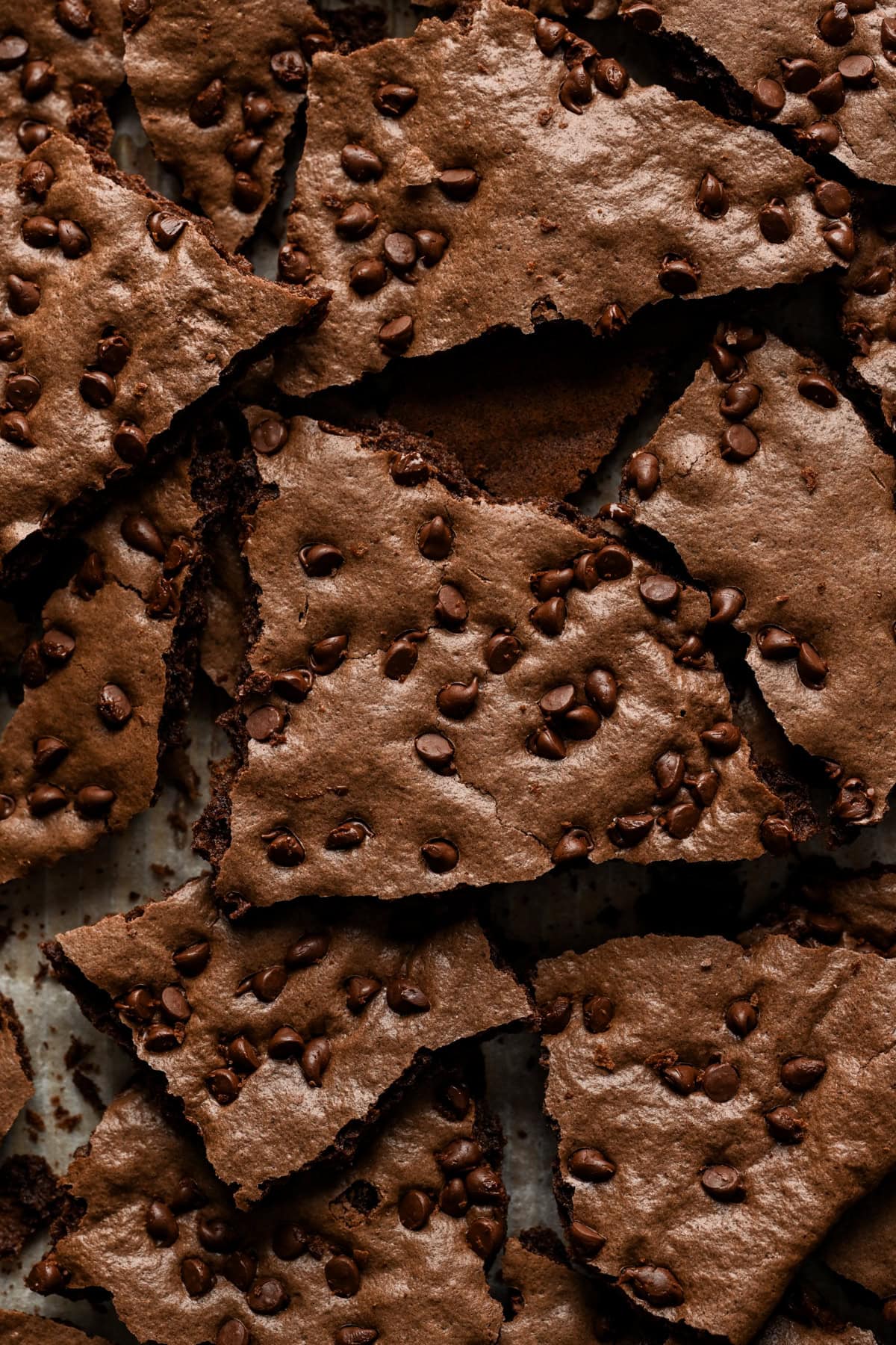 Overhead view of brownie brittle broken up into pieces.