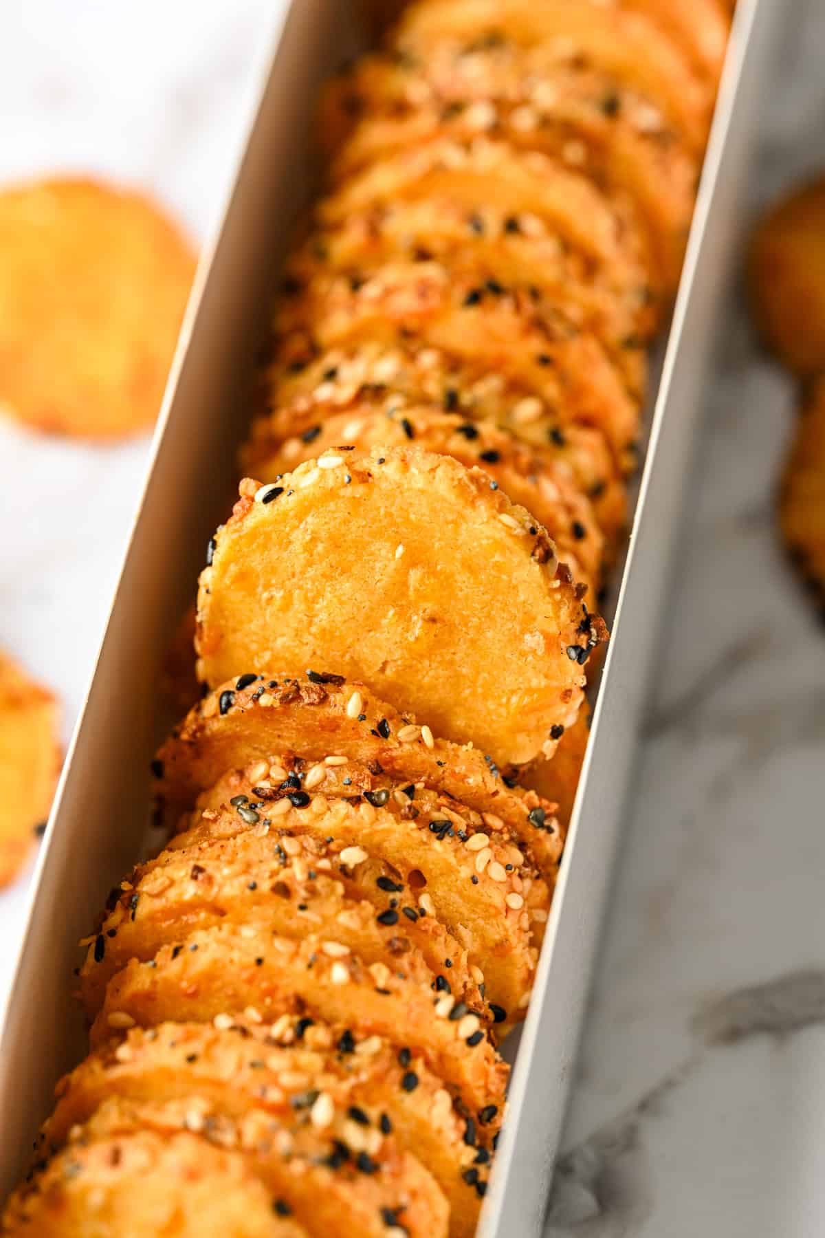 Cheddar cheese coins in a box.