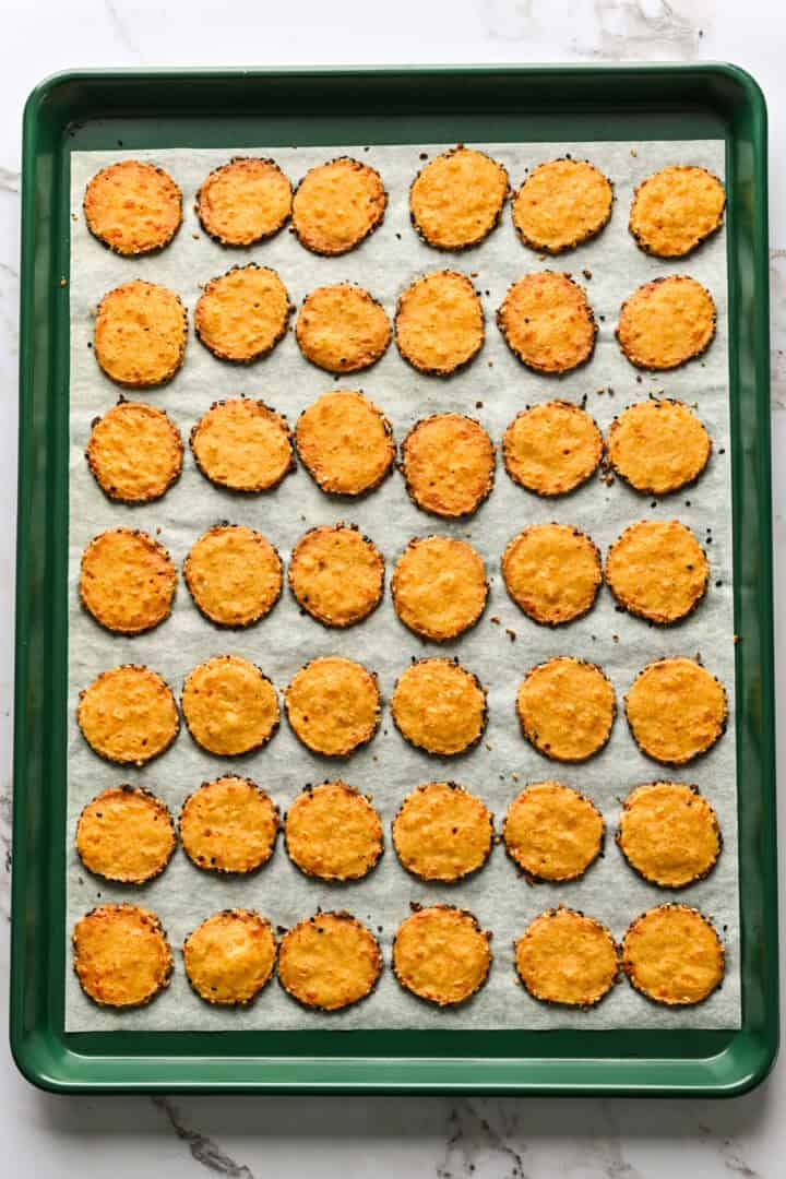 Overhead view of cheddar cheese coins after baking.