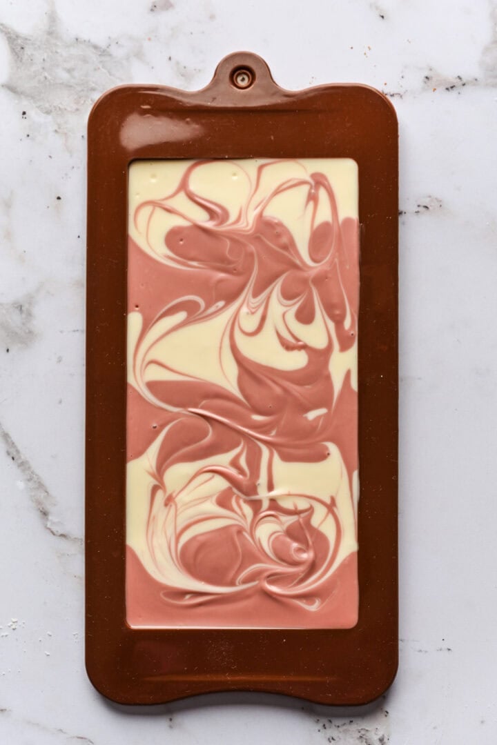 Overhead view of ruby and white chocolate bar with swirled chocolate