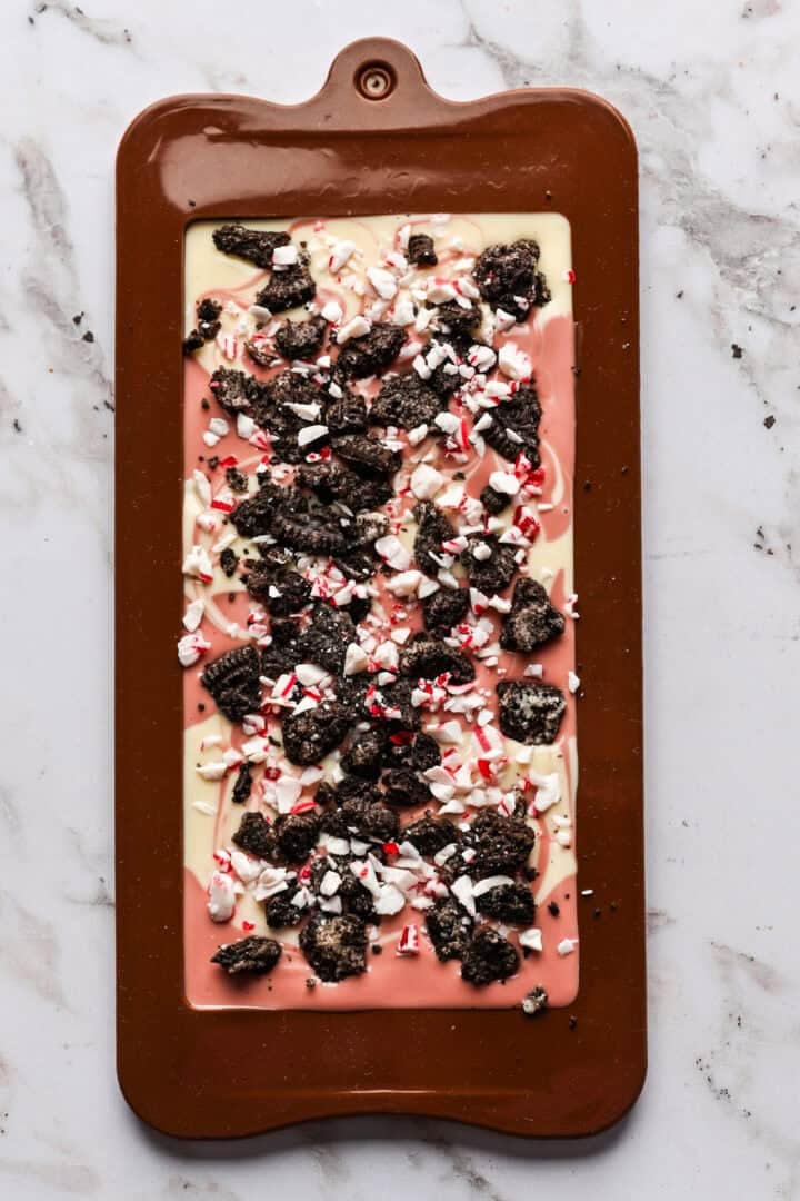 Overhead view of ruby and white chocolate bar with oreo pieces.