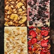 Overhead view of four chocolate bars with varied toppings.