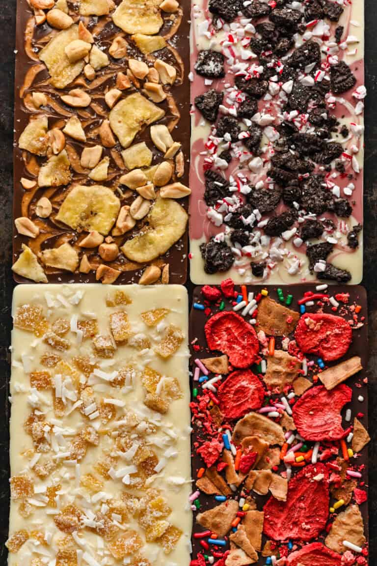 Overhead view of four chocolate bars with varied toppings.
