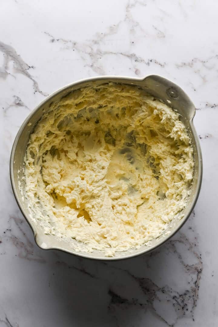 cream cheese, feta and goat cheese mixed together in a bowl.