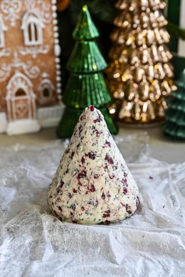 Cheese ball mixture shaped into a cone.