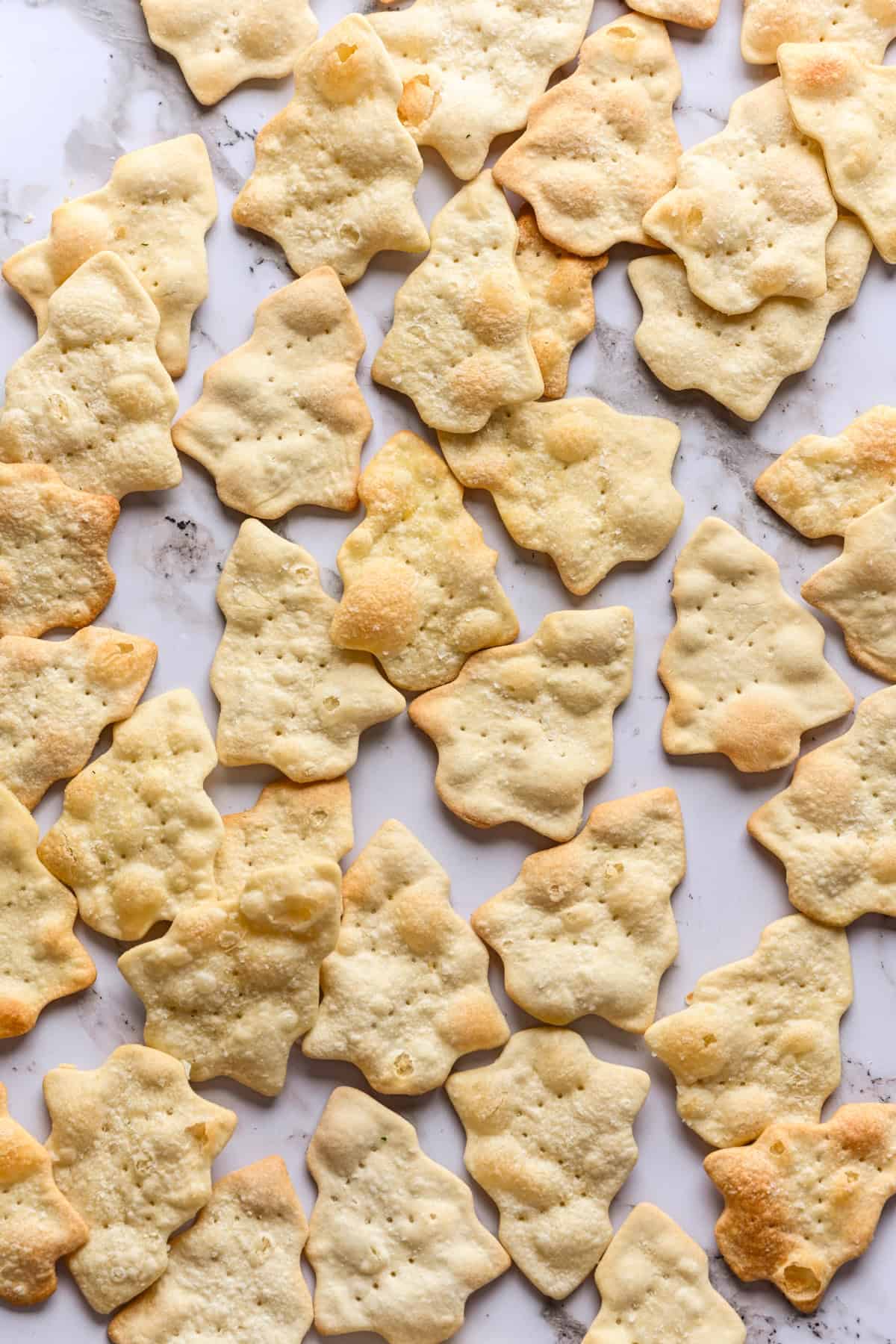 overhead view of christmas tree shaped crackers on marble.