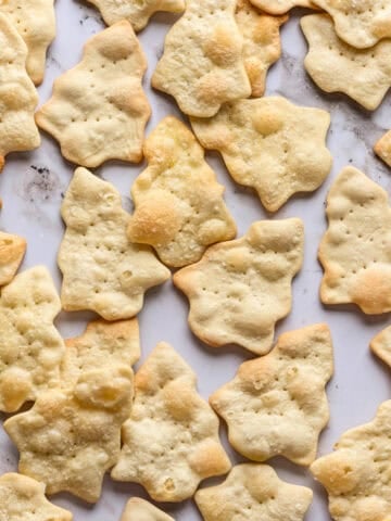 overhead view of christmas tree shaped crackers on marble.
