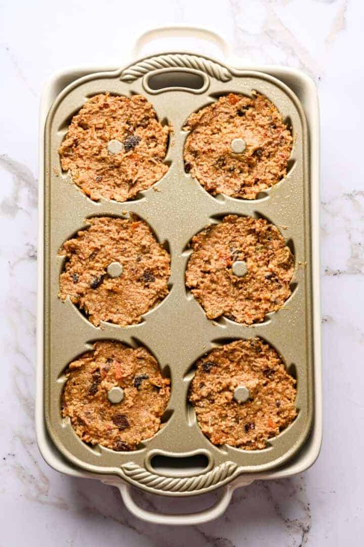Figgy pudding in bundt tins before baking.