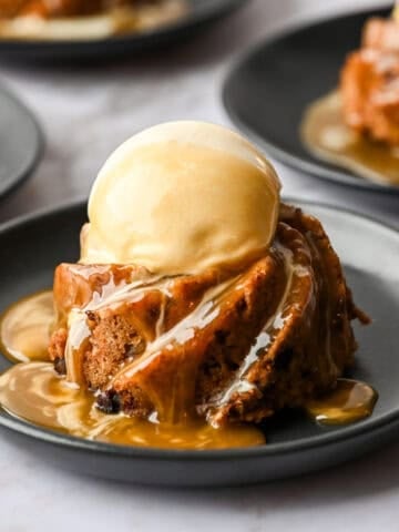 Mini figgy pudding topped with ice cream and caramel sauce.