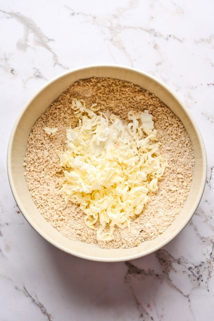 Figgy pudding dry ingredients topped with grated frozen butter and shortening.