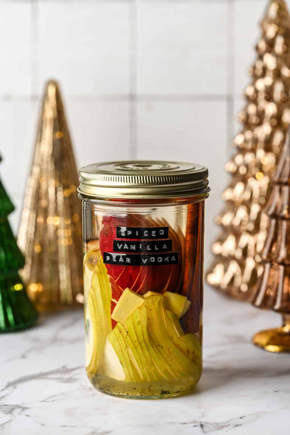 Spiced vanilla pear vodka in a jar before it's infused.