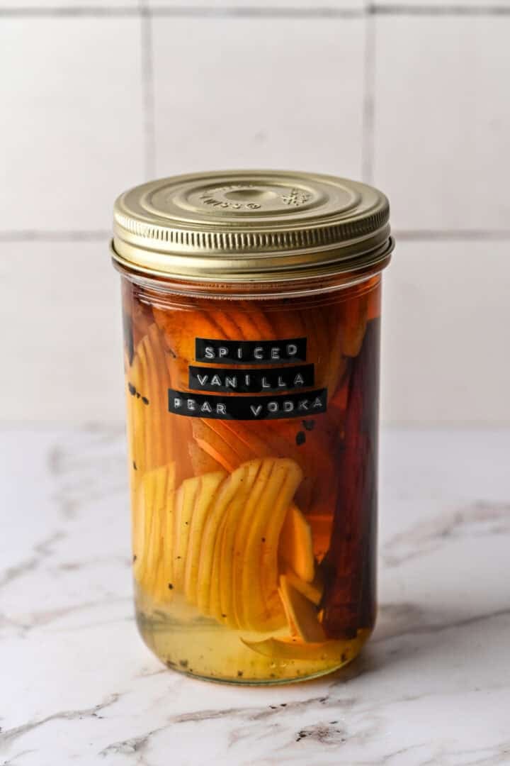 Spiced vanilla pear vodka in a jar after it's infused.