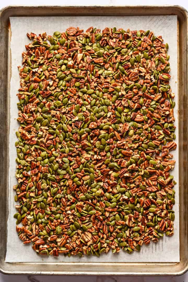 Pecan pepita brittle on baking sheet before baking.