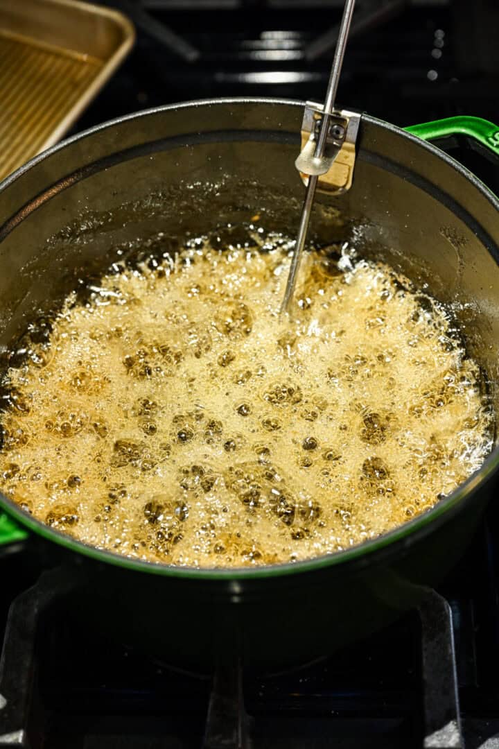 Sugar, honey and water boiling in a pot.