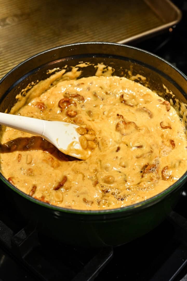 Peanut brittle mixture bubbling up in a large pot.
