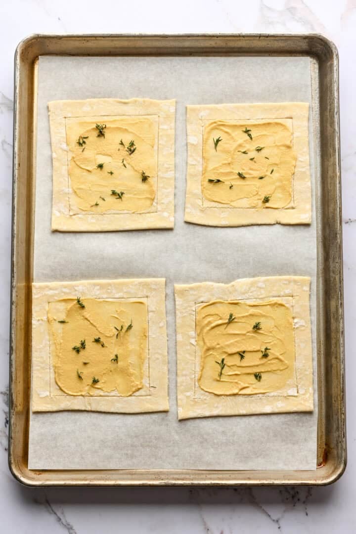 Overhead view of puff pastry with dijon and herbs.