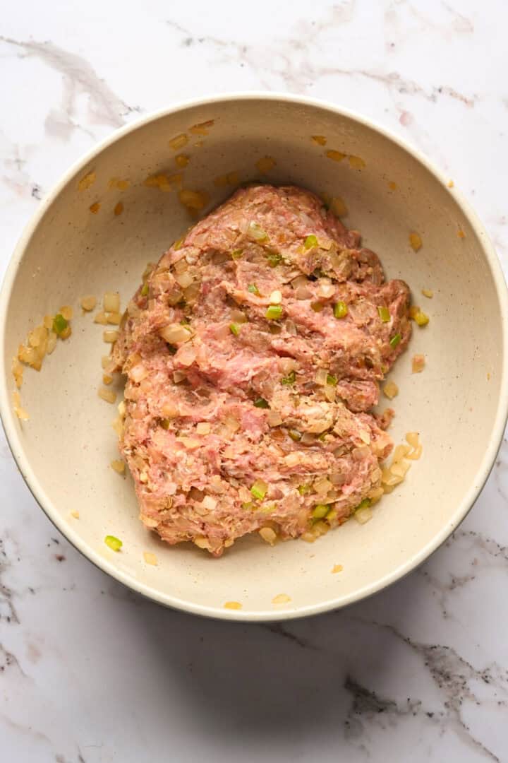 Sausage ingredients in a mixing bowl after mixing together.