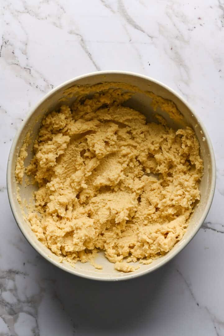 Sugar cookie dough in a white mixing bowl.