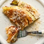 Overhead view of cabbage wedge with caesar dressing and parmesan.