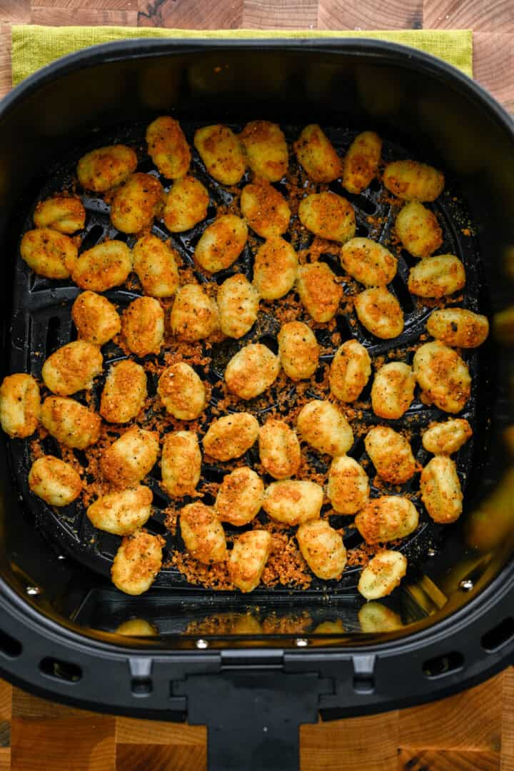 Gnocchi in the air fryer basket after cooking.