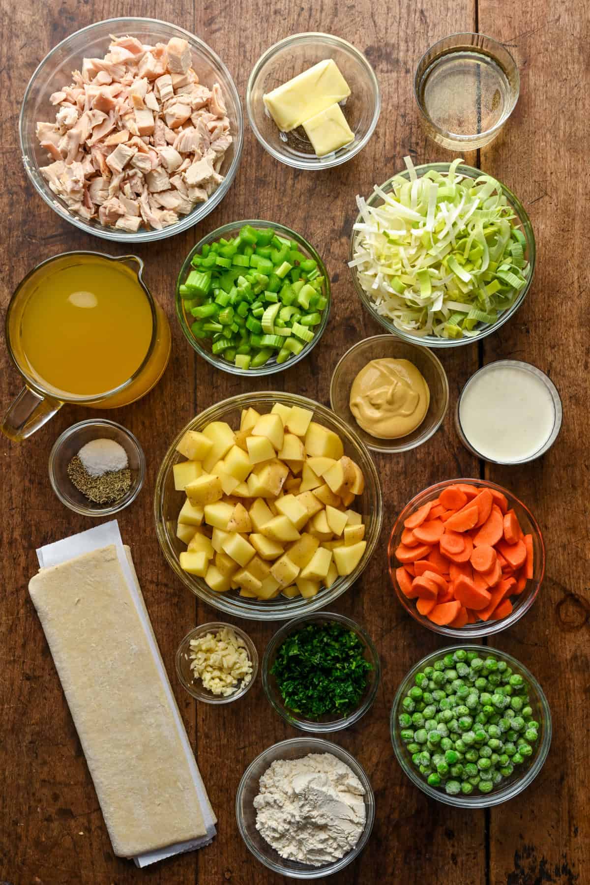 Overhead view of chicken pot pie soup ingredients, including chicken and puff pastry.