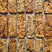 overhead view of 4 flavors of granola bars on a sheet pan.
