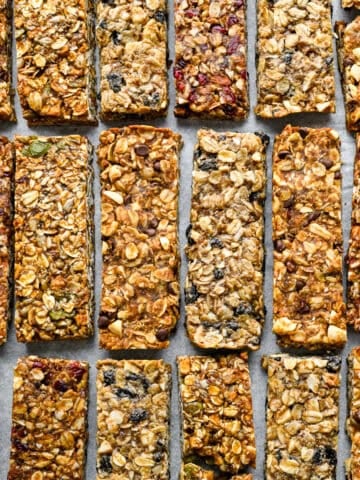 overhead view of 4 flavors of granola bars on a sheet pan.
